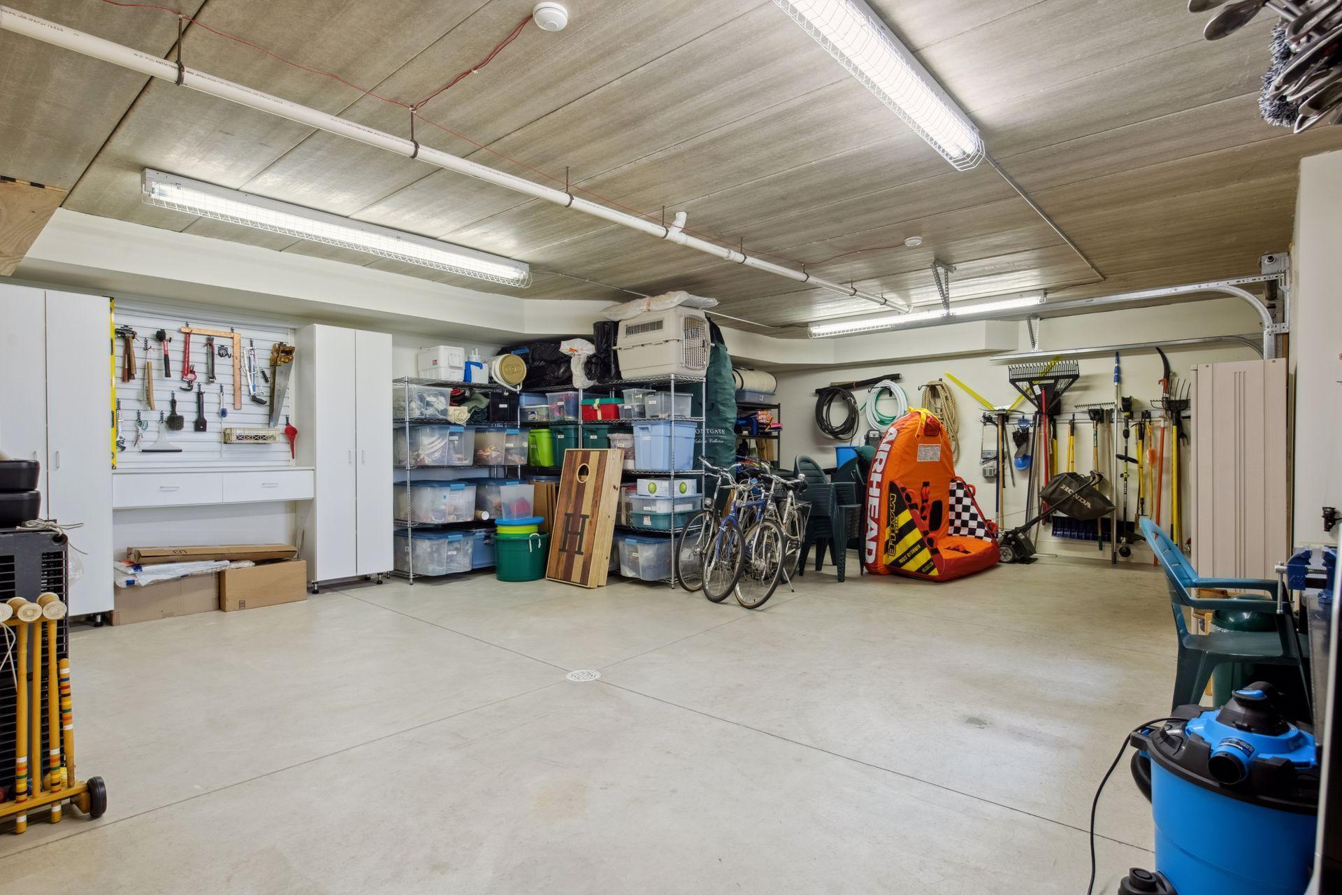 THIS space is AMAZING! This is a mirrored space like 3 car above, span Crete tuck under garage with garage door to access the backyard when walking to the lake. the lake. Great for lake toys, tools, yard games, work bench and more.