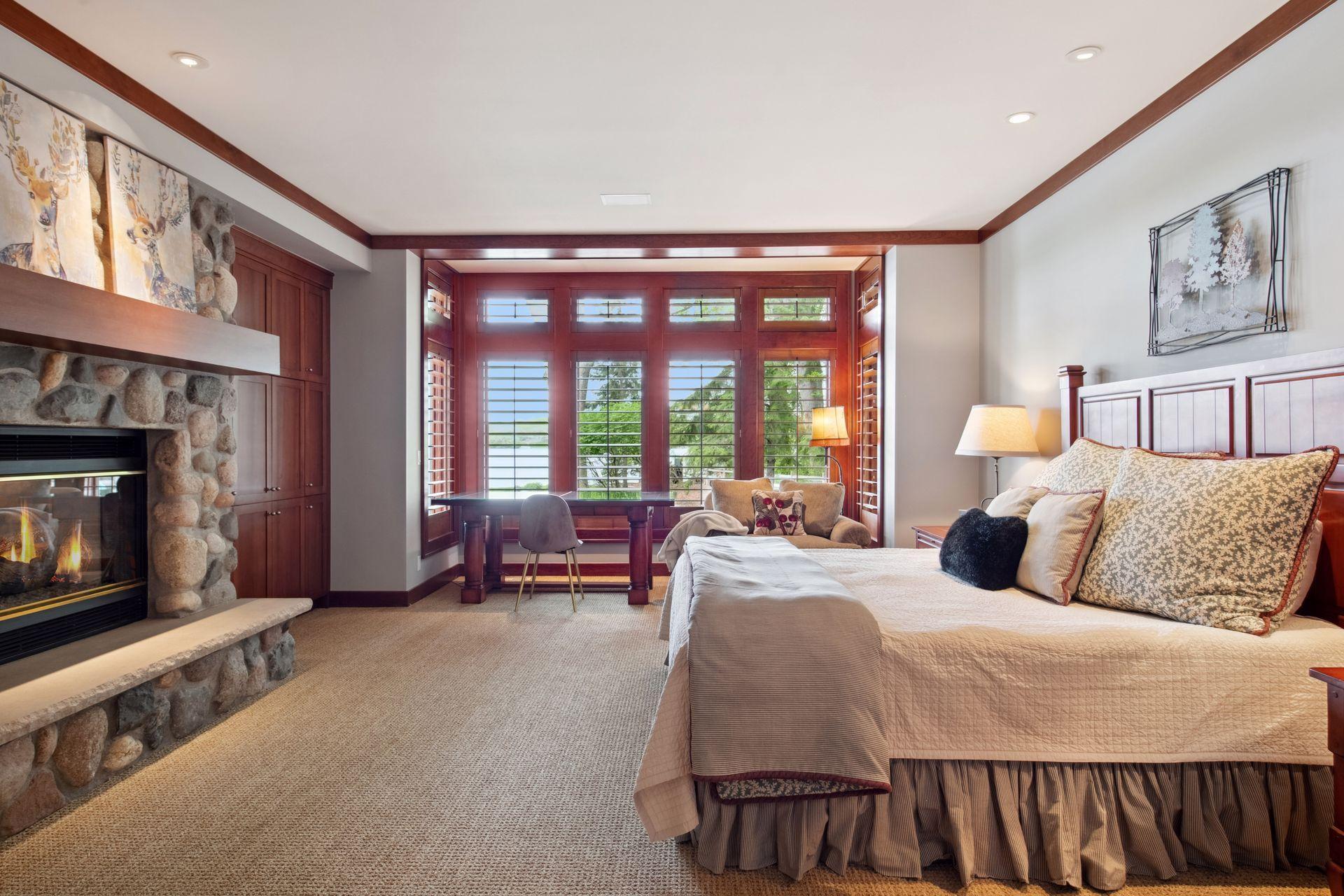 This bedroom is much like the primary bedroom which includes gas fireplace and sweeping views of the lake.