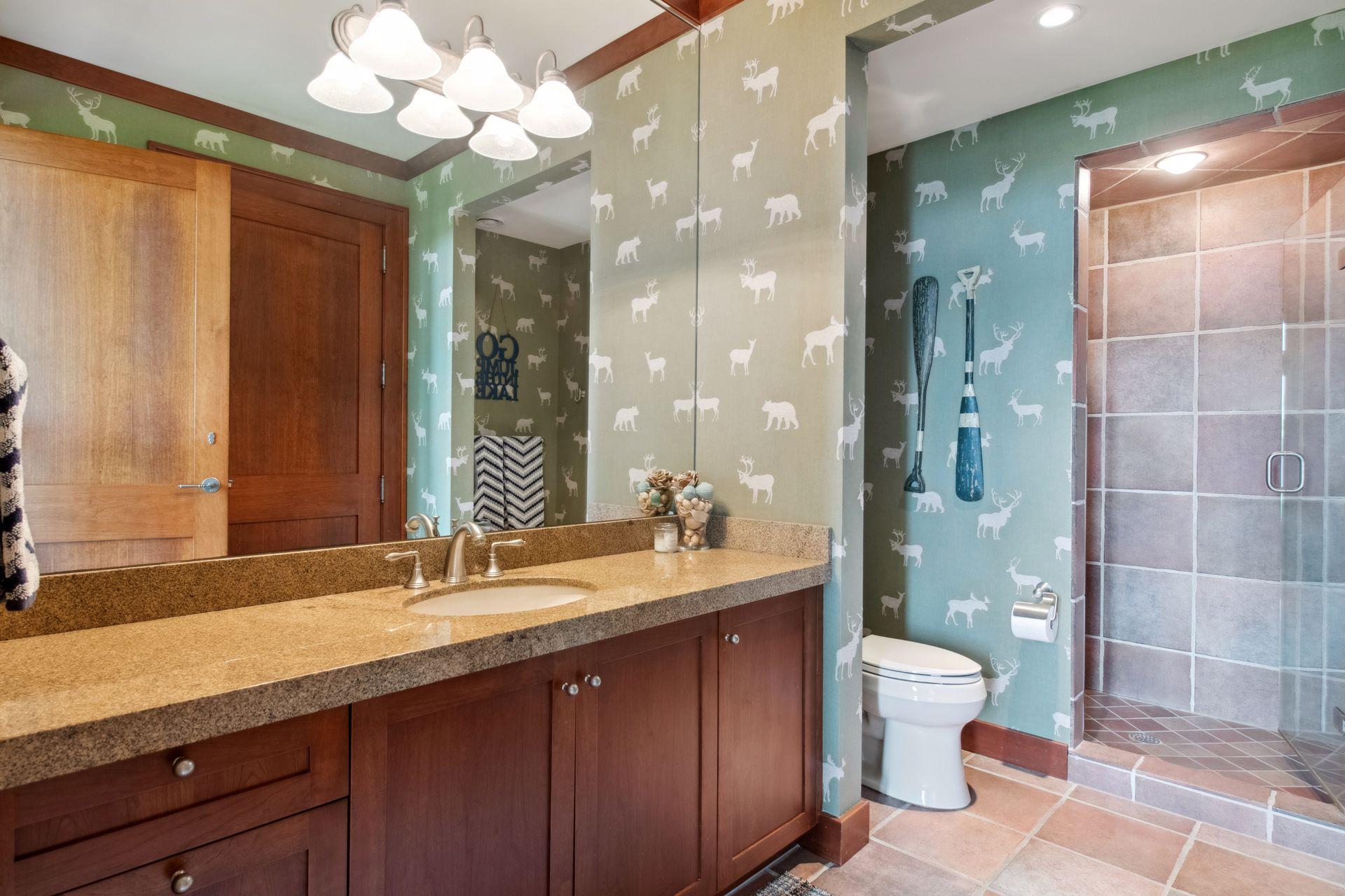 3/4th bathroom which is part of lower level bedroom two en suite. This bathroom also is located right by exterior door for ease of lake traffic.