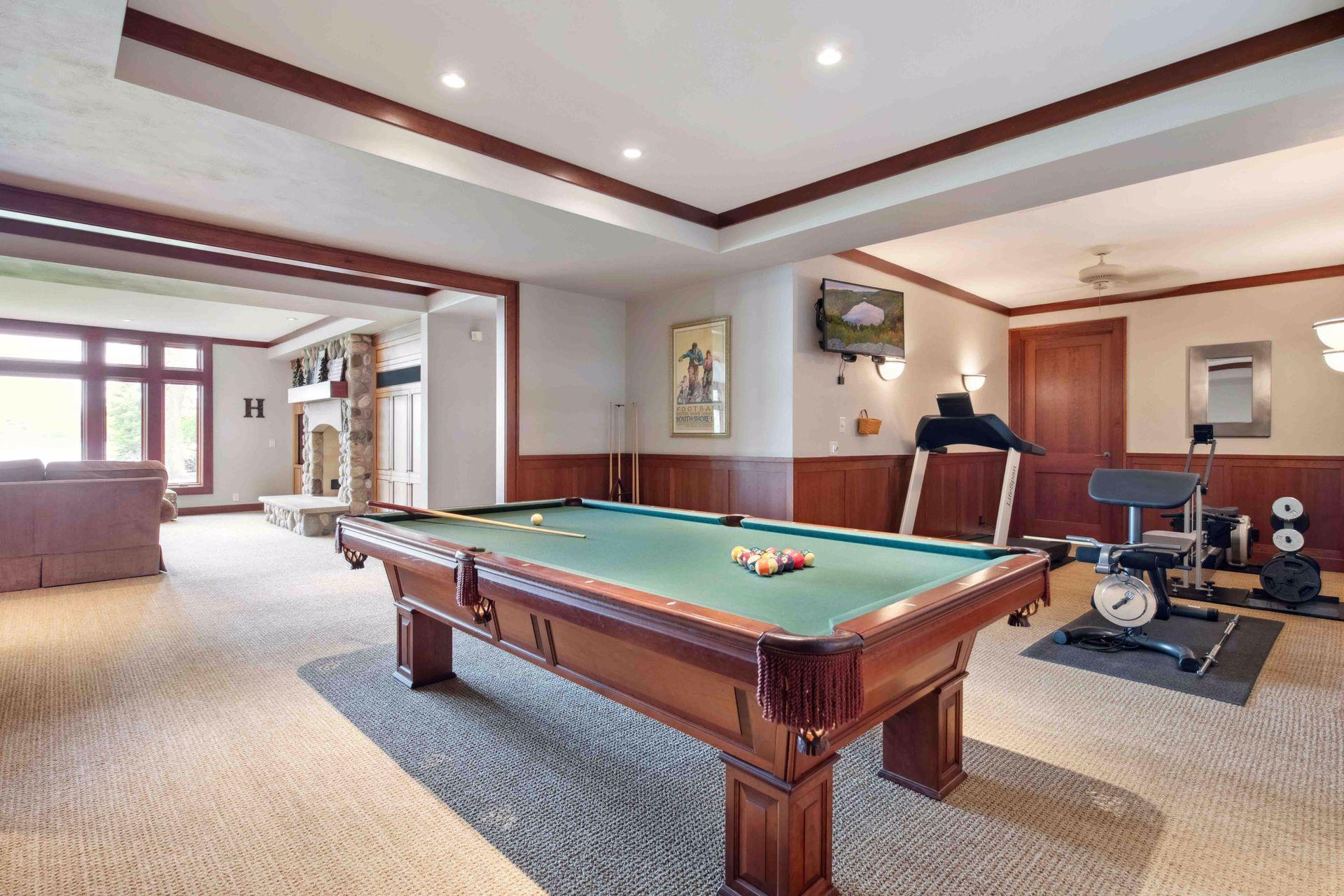 Billiard room and exercise area with TV. Behind the door is the well equipped mechanical room.