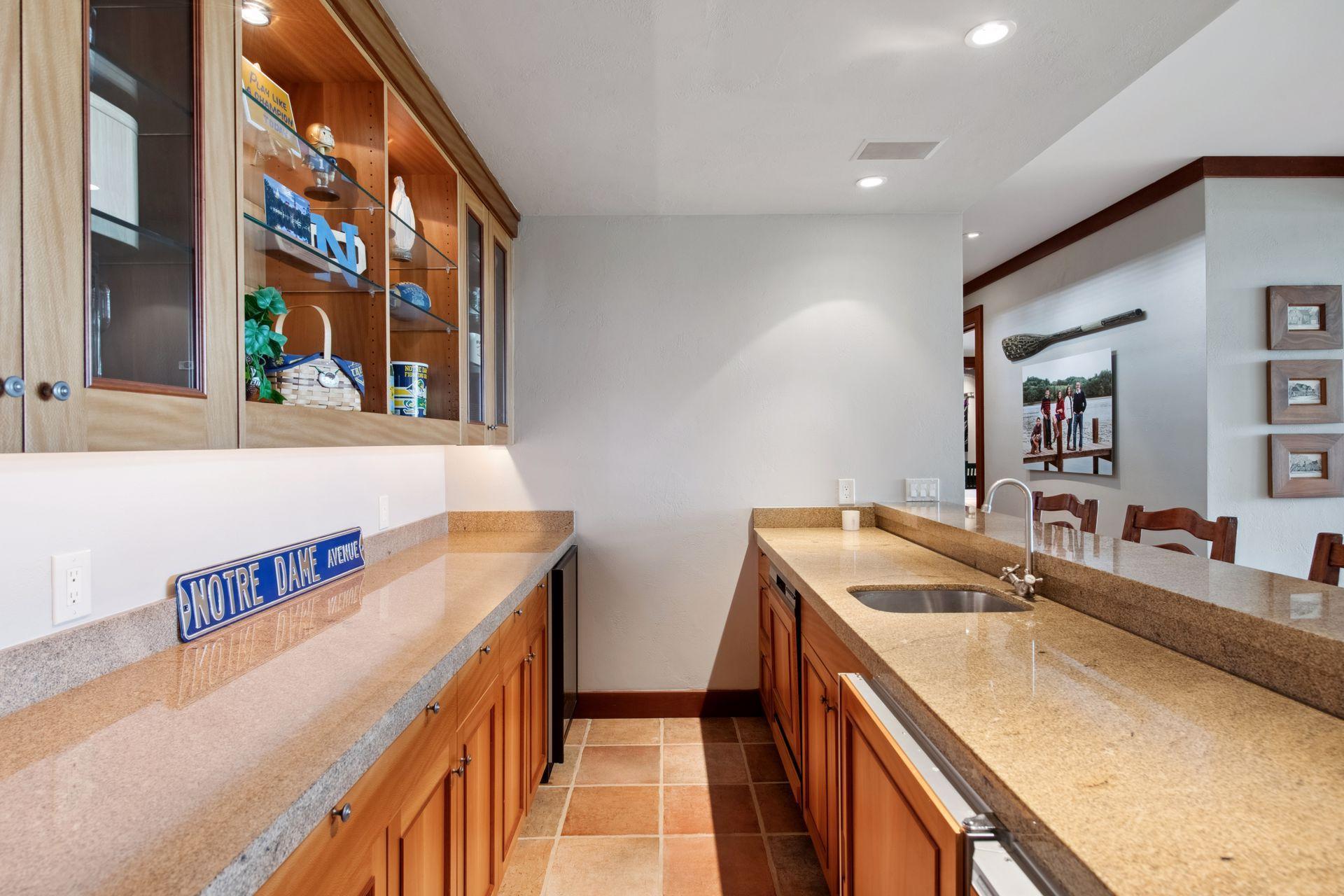 Wet bar is equipped with dishwasher, beverage refrigerator, wine refrigerator and icemaker to make entertaining a breeze.