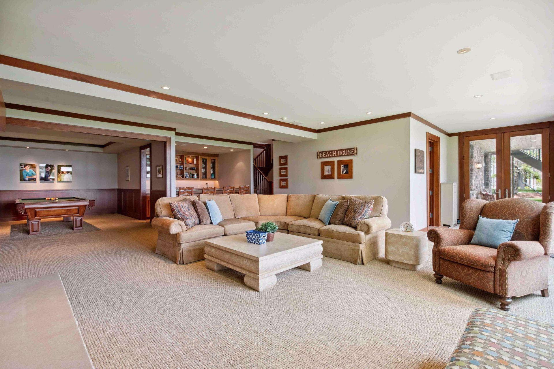 View from corner TV towards lower level exterior door to the outside. 3/4th bath is also right there on the left prior to going outside. This bathroom is for ease of all lake traffic coming in and out from boating with tile flooring.