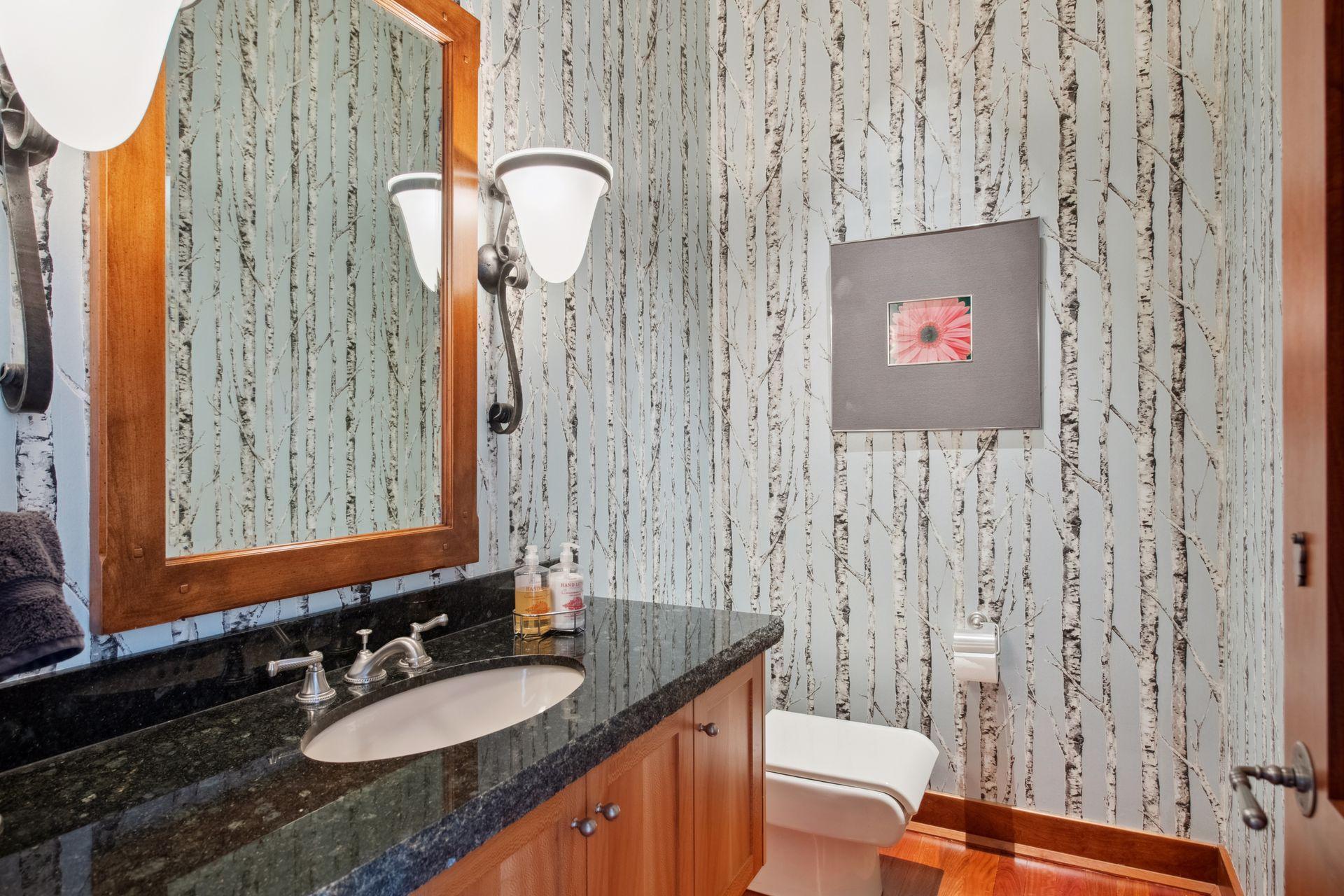 First half powder bath located directly off main level living room and next to luxurious den/office currently with grand piano.