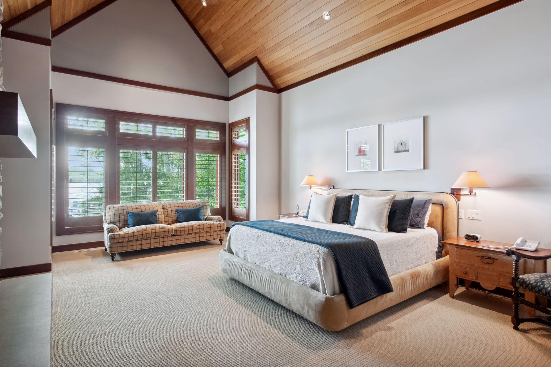 Main level primary that faces the water with 20ft soaring ceilings.