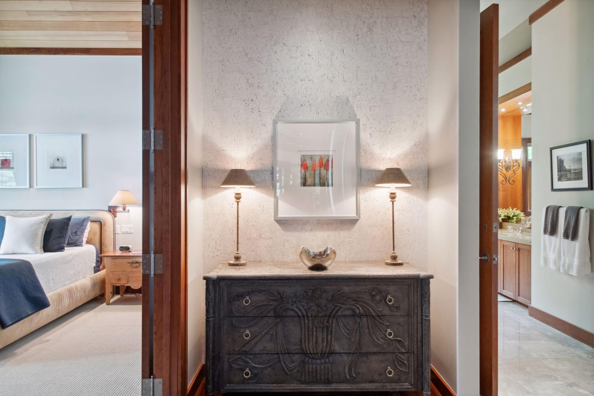 Welcome to the primary suite. A wing all to its own. Bedroom on the left with primary spa like bath with walk in closet to the right.