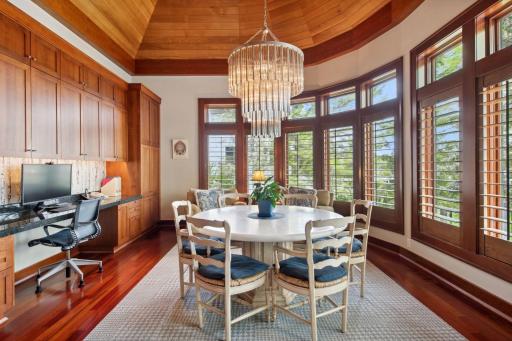 Informal dining surrounded by long vista water views and lush mature trees. Home also comes with real wood blind shutters. Kitchen desk area/work station is a great spot to peruse on the computer or have kids do their homework.