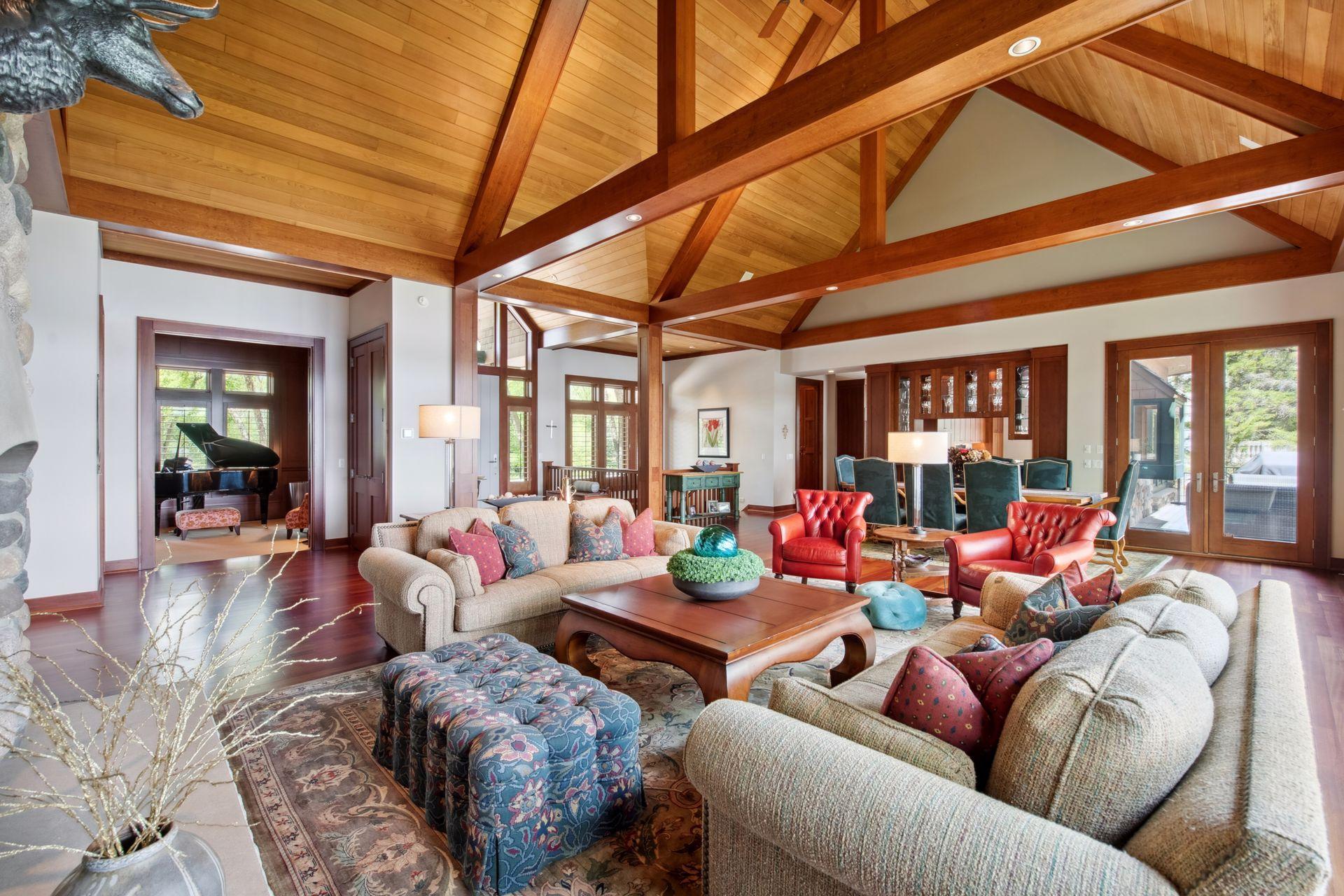 View from corner of main level living room into formal office / den space large enough to accommodate a baby grand piano.