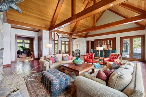 View from corner of main level living room into formal office / den space large enough to accommodate a baby grand piano.