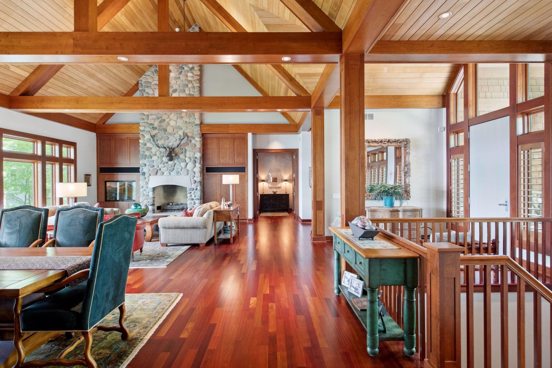 View from kitchen to main primary owner suite wing. Beautiful cedar vaulted ceilings throughout main level.