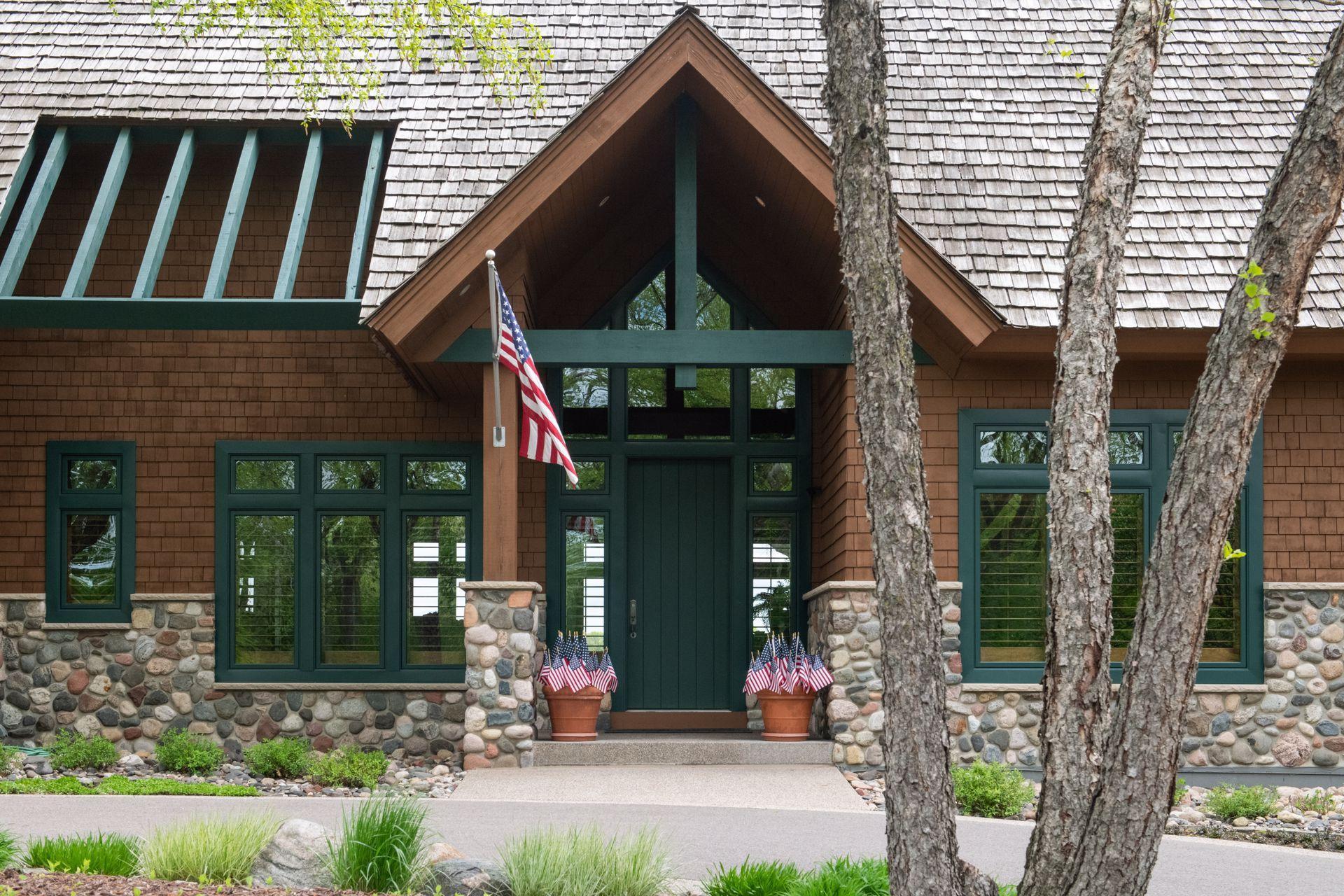 Custom solid front door with soaring windows and vault welcome you or your guests year round.