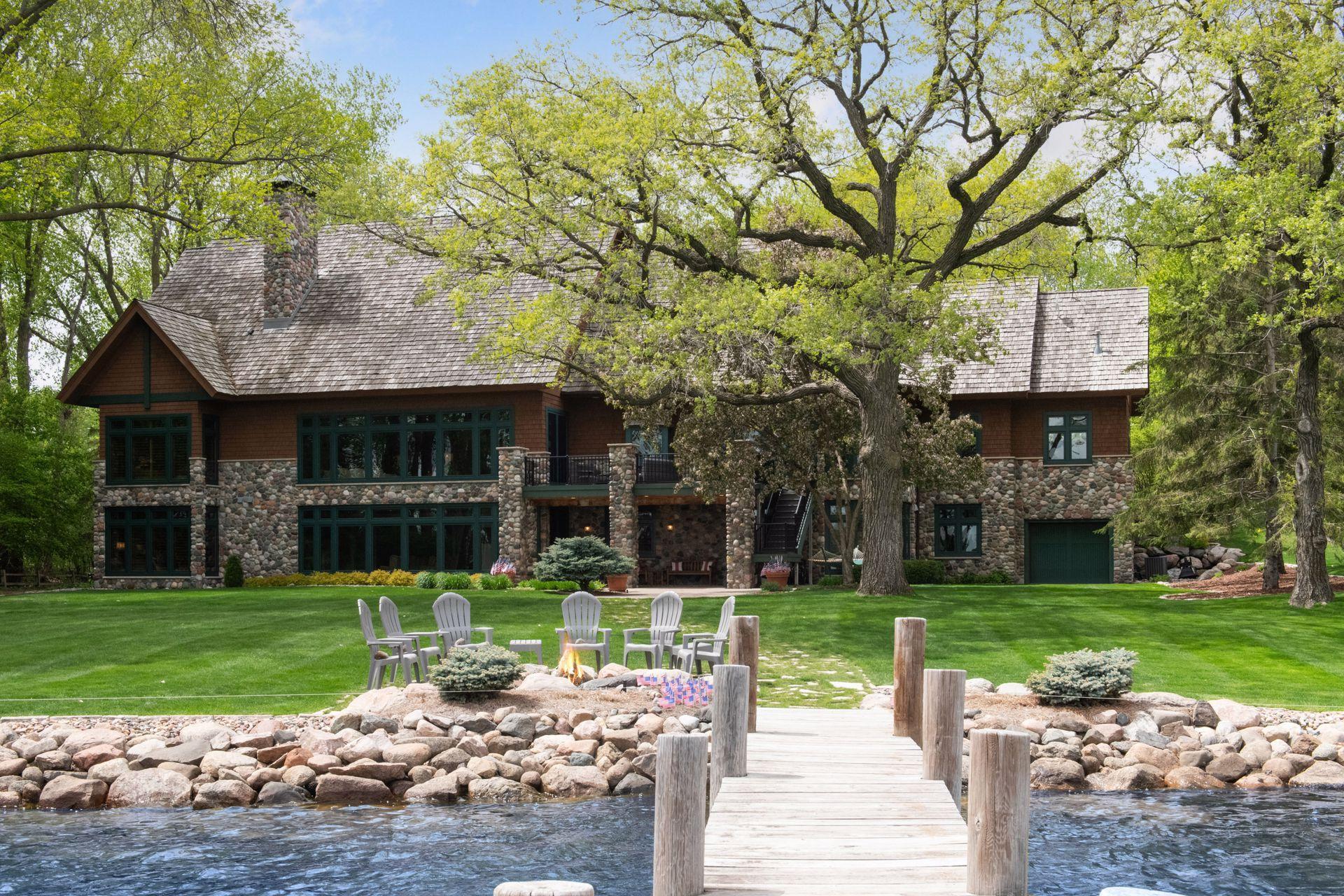 Welcome home to 6941 Beach Road on Bryant Lake with 167ft direct level lakefront - Full recreational lake