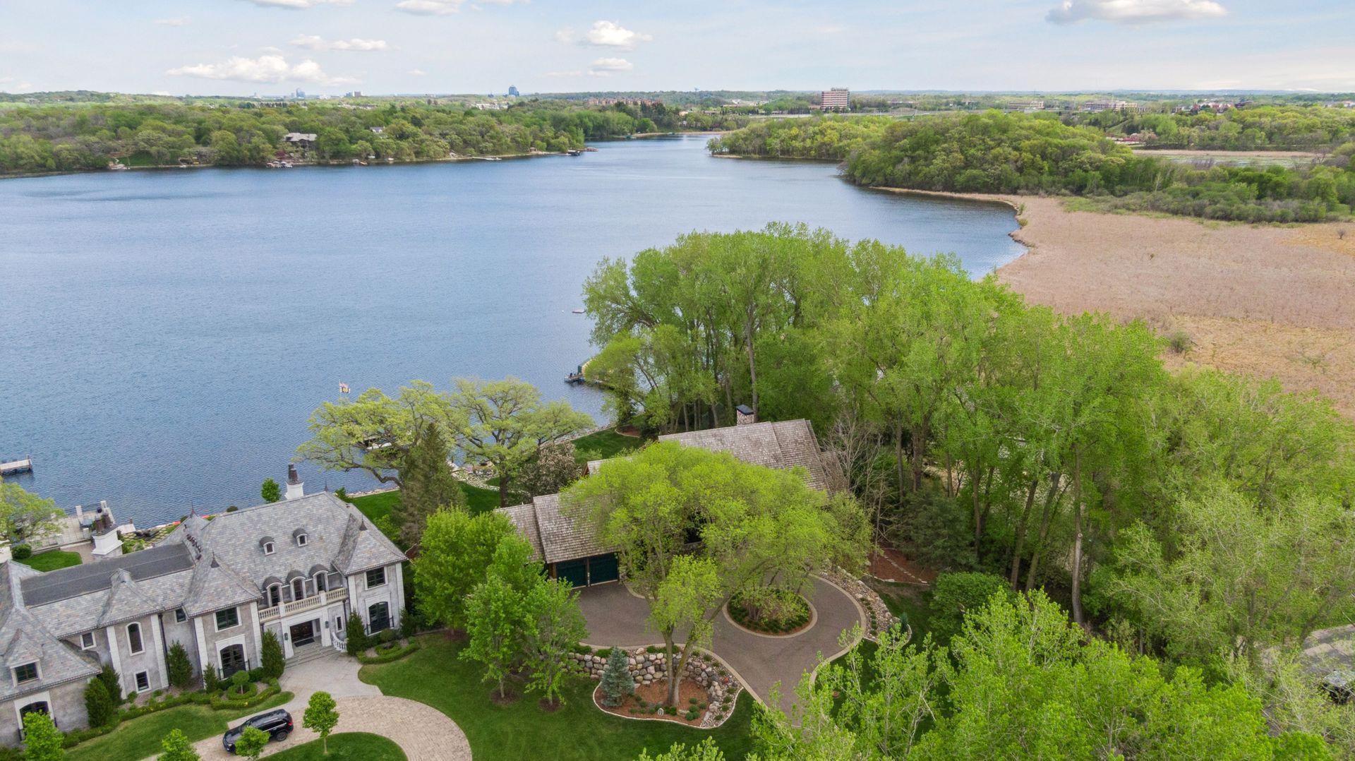 Aerial view of home located on widest part of Bryant Lake - 180 acre lake recreational lake. This home is located at the very end of Beach road for ultimate privacy and serenity with pond across the street adding additional privacy.