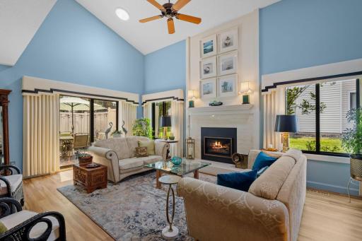 Welcome to your beautiful 2-story vaulted living room! This spacious, light-filled area offers direct access to the back patio, making it perfect for both relaxing and entertaining. It's a well-loved space that's sure to be a favorite gathering spot.