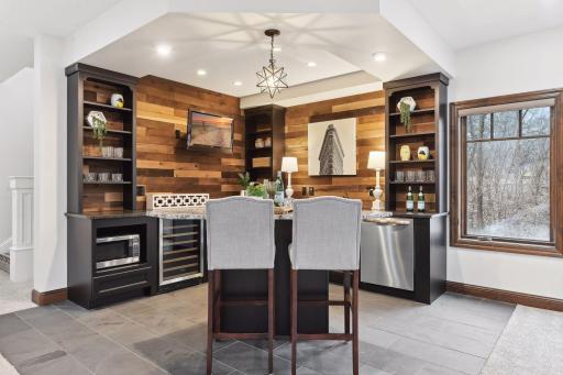 Wet bar complete with dishwasher, wine fridge & microwave. Perfect for entertaining!