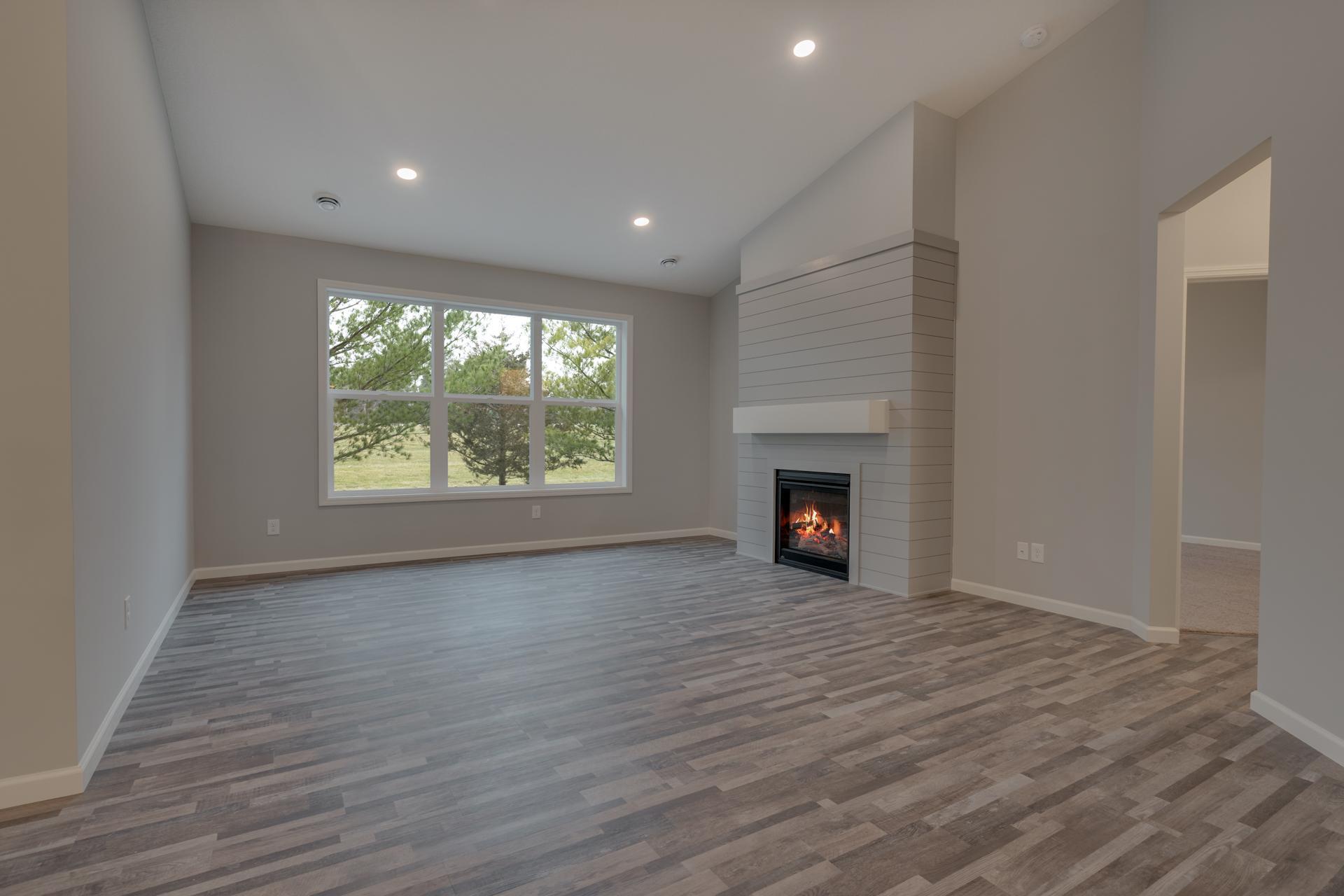 Photo is of the same floor plan, but not exact home. Colors and build variations will occur. Photos of actual home will be uploaded once interior of home is cleaned. Actual home will have stone fireplace.