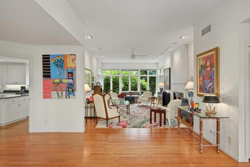 Family room with a wall of windows overlook in the backyard