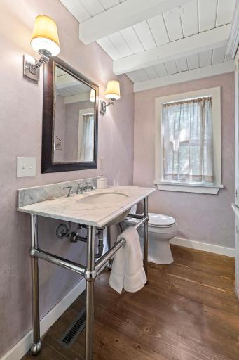 Main level powder room with marble console vanity