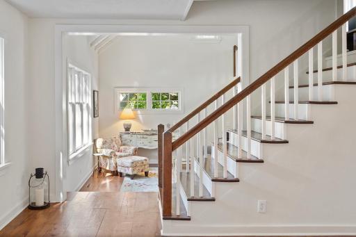 The front entry way is open to the living room addition space with a loft and side entry from the garage.