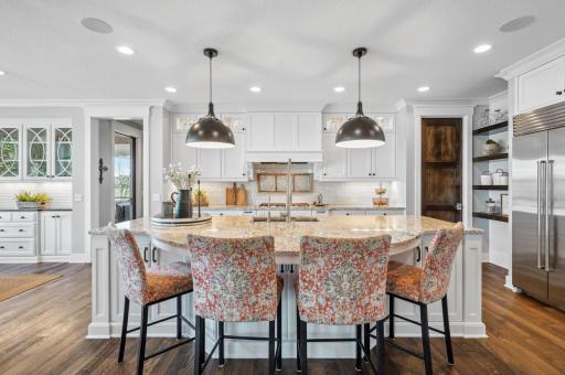 The kitchenâs custom cabinetry extends to the ceiling complete with lighting. Large pantry also offers an abundance of storage space and a Sub Zero bar fridge