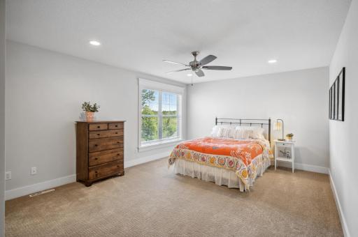 The fourth bedroom on the upper level is a spacious and inviting room, ideal for a variety of uses. The large window fills the room with natural light, while the generous closet provides plenty of storage.