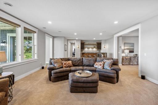 This spacious area is ideal for movie nights, gatherings, or simply relaxing while enjoying the seamless connection to the backyard.