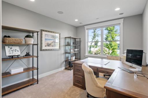The lower-level full office is a dedicated workspace designed for productivity and focus. Natural light filters through the windows, creating a bright and inviting environment.