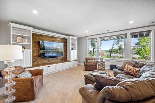 The lower level family room is a perfect blend of comfort and entertainment, featuring a built-in entertainment center and easy walk-out access to the outdoors.