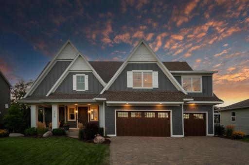 The fully finished & heated three-car garage, complete with Hardi wainscoting and two floor drains, offers both style and convenience.