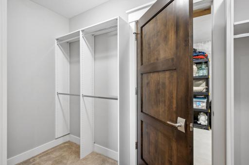 The lower-level closet, discreetly opens into a spacious storage room. This storage space is subtly roughed in to serve as a potential "safe room" making it both a practical storage solution and a secure space when needed.