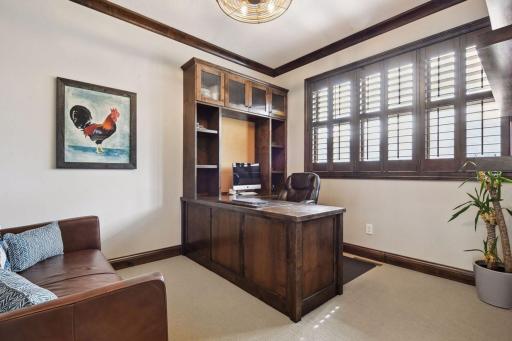 Main floor Office with built in desk, shuttered windows