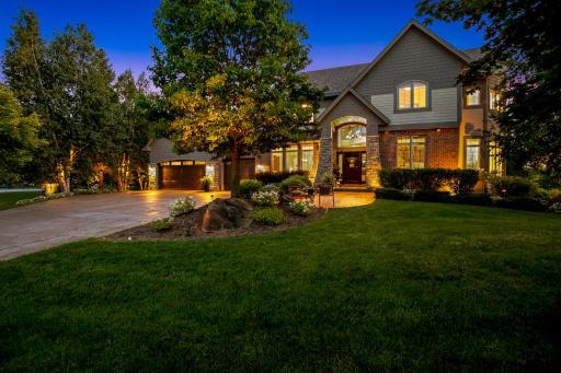 Stamped concrete driveway and sidewalk lead to this beautiful home