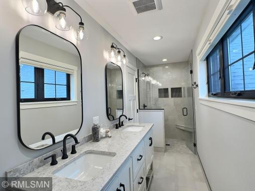 The owner's suite features a three-quarter bathroom with glass shower, double sinks and tons of light.