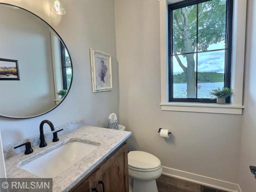 Just off the garage and back foyer is a half bathroom with gorgeous finishings, perfect for when guests visit.