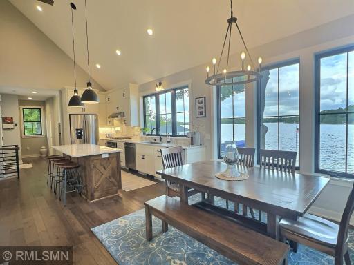 The dining room opens to the kitchen and is complete with a upgraded chandelier and vaulted ceiling.