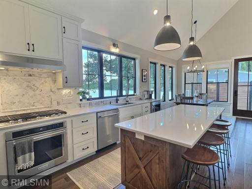 This kitchen is what dreams are made of, two-toned cabinets and bright countertops set the tone for the space.