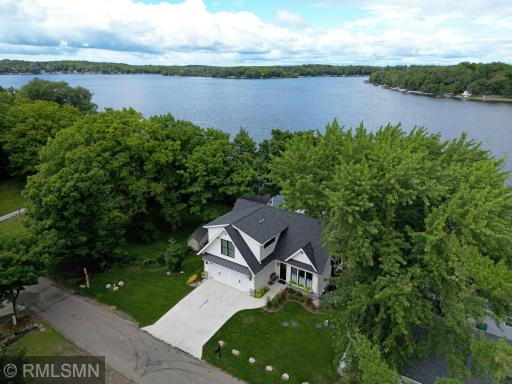 Fresh air awaits, savor the outdoors with gorgeous meticulous landscaping and lush green grass leading to the lakeside.