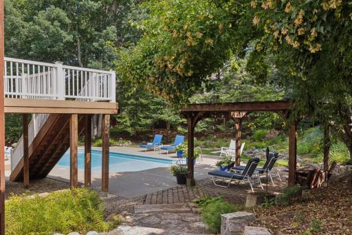 A stone path leads you the secluded backyard, brimming with trees, perennials, and natural beauty!