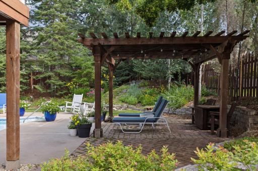 You'll love relaxing in the shade of the custom pergola!