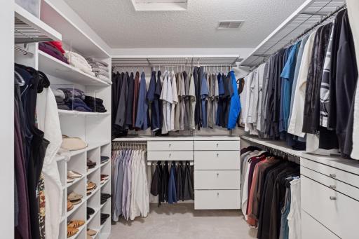 Spacious and sleek walk-in closet, designed for maximum storage and organization!