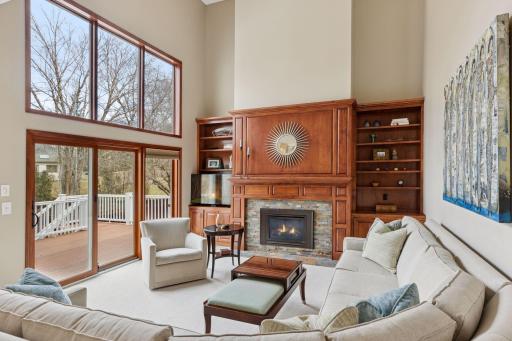 Open, sunlit family room: triple sliding doors with transom windows to the deck. Gas fireplace with built-ins adds a cozy elegance!