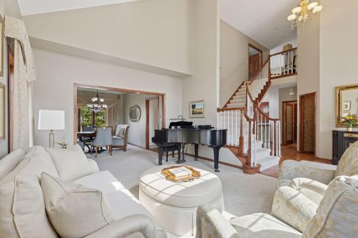 Refined open living/dining space with vaulted ceilings and grand staircase!