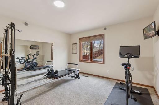 The lower-level 5th bedroom provides a versatile area, presently configured as a gym, with ample room for various uses!