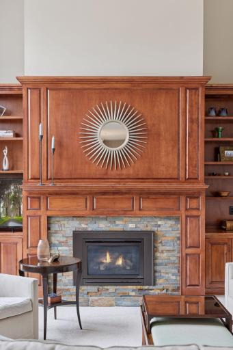 Classic woodwork surrounds the refurbished gas fireplace, with custom built-ins!