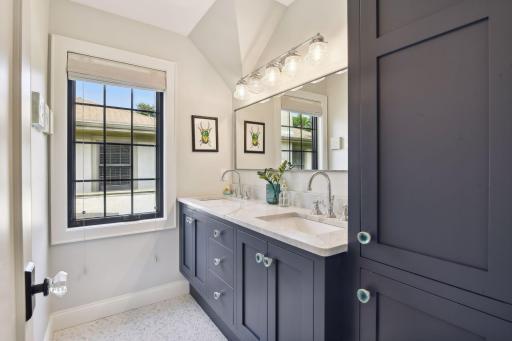 Hall bathroom with dual vanities and marble countertop