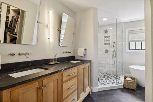 Soapstone countertop, slate heated floors, marble shower with separate wand and showerhead, freestanding soaker tub