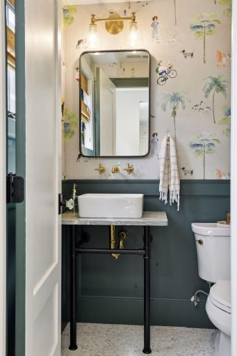Main floor powder bath with adorably whimsical wallpaper!