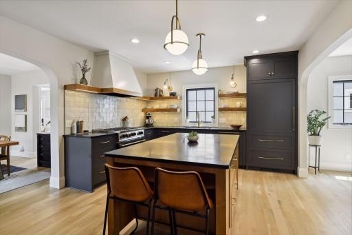 Deep blue cabinets, panel fridge, open display shelving
