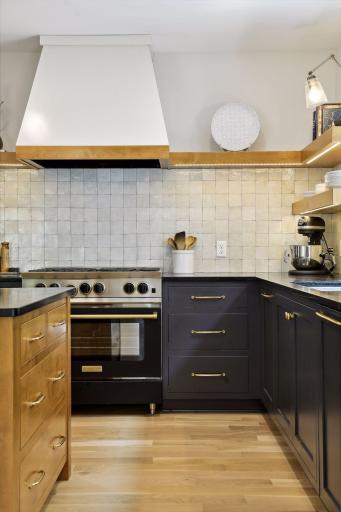 BlueStar Cooking Range, Alder wood center island with soapstone countertop, Moroccan zellige tile backsplash, unlacquered brass hardware