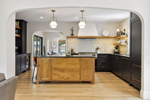 High end chef's kitchen teeming with custom finishes