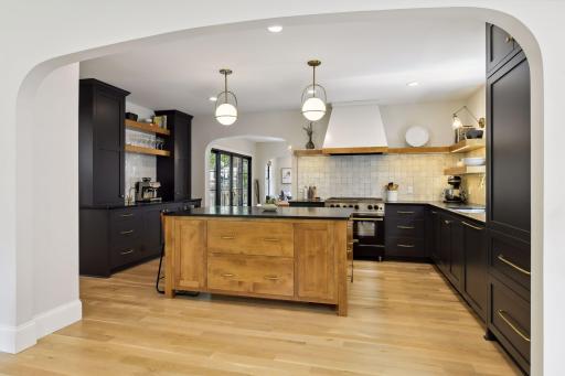 High end chef's kitchen teeming with custom finishes